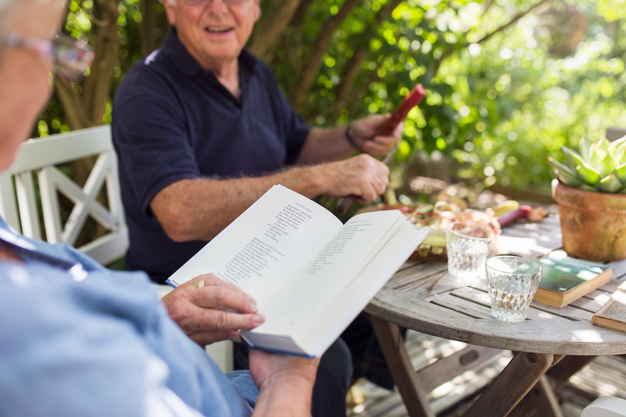 Senior woman reading book on patio